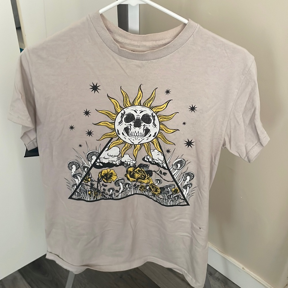 Spencer’s tan shirt